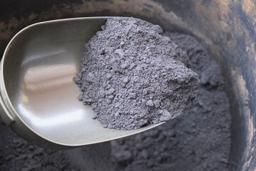 Close view of iron ore concentrate into the hand shovel