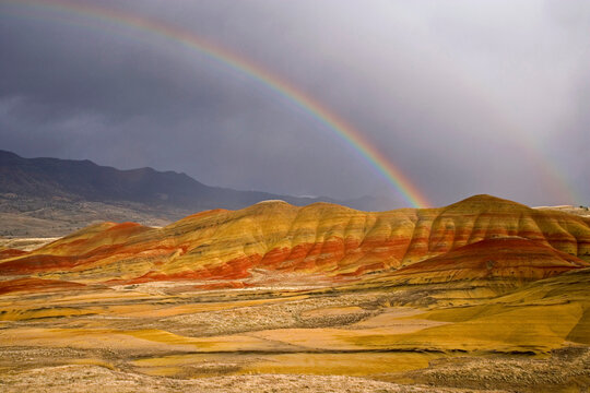 Rainbow over hills, Painted Hills, John Day Fossil Beds National Monument, Oregon, USA