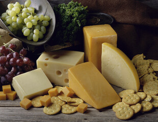 Close-up of cheese with crackers and grapes