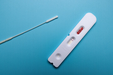 Isolated kit of coronavirus antigen test on blue background. Color illustration photo of the covid epidemic or testing.