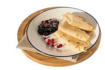 Fresh Russian delicious pancakes with currant jam on a white plate. 