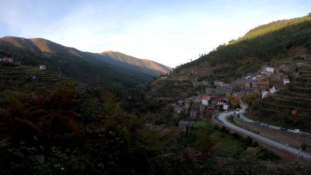 PAN SHOT SLOW MOTION - The picturesque little schist village of Piod&atilde;o clings to a steeply terraced mountainside deep within the foothills of the Serra de A&ccedil;or range in central Portugal.