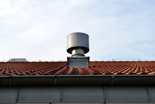 metal chimney on the roof against blue sky