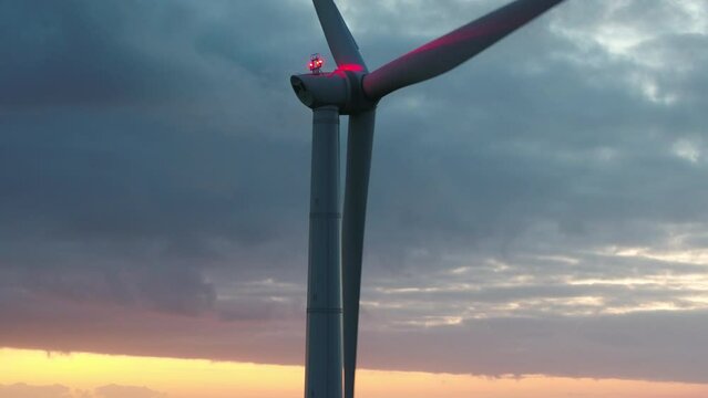Wind turbine with anti-collision light at dusk, Eemshaven, Netherlands