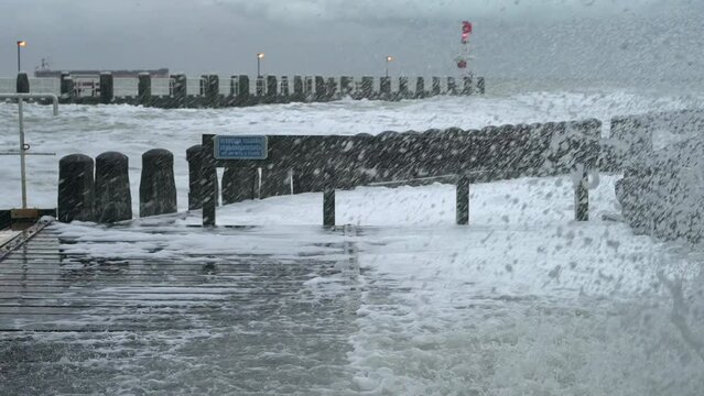 Sea waves on pier during storm called Corrie, Vlissingen, Netherlands