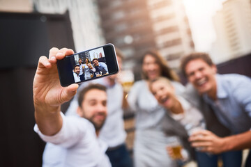 Making memories after work with colleagues. Cropped shot of businesspeople having drinks on their office balcony.
