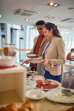 Young business people are self serving with delicious food at the canteen. Business, people, company