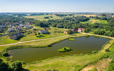 Fototapeta premium Chapsky's estate in the village of Priluki. The manager's house and the brewery building. Black lake. Minsk region. Belarus. View from above. aerial photography