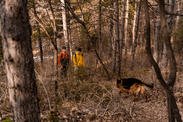 Hiking up the hill with their dog