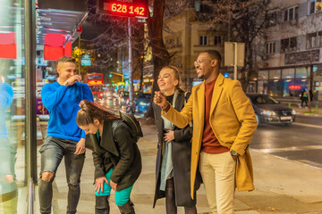 Obraz premium Laughing all together in front of the shop while standing and talking