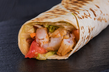 Shrimp doner on a black slate tray