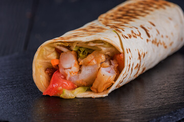 Shrimp doner on a black slate tray