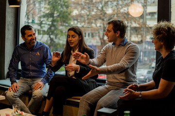 Talking and laughing together in the cafe while discussing