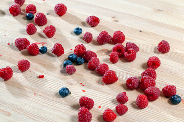 harvested red ripe raspberries on the table