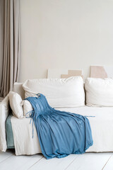 Bright room interior in white tones and sunlight with stylish women's dress. Interior design.