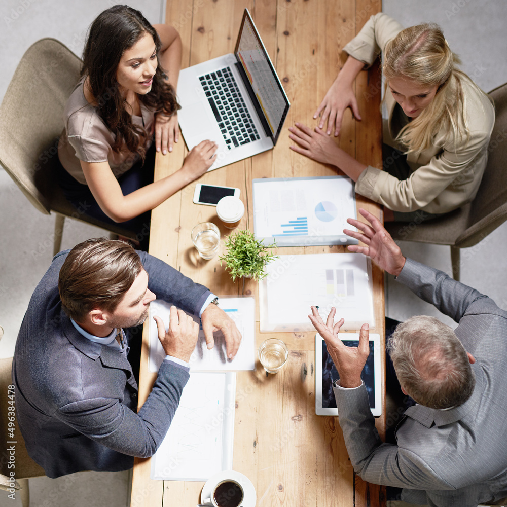Poster Discussing the way forward with their plans. Shot of professional colleagues working together in a modern office.