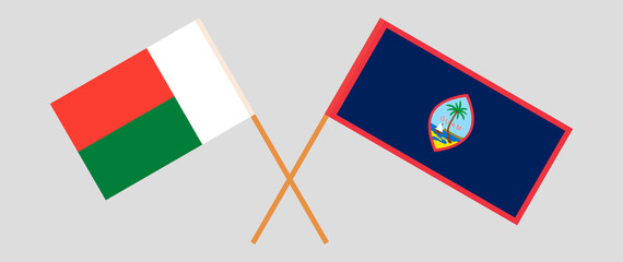 Crossed flags of Madagascar and Guam. Official colors. Correct proportion