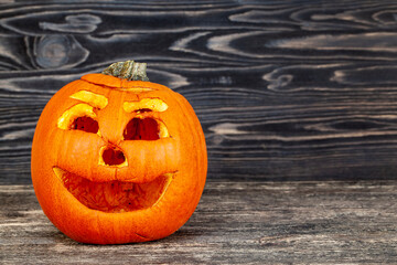 preparing an orange pumpkin for Halloween celebration