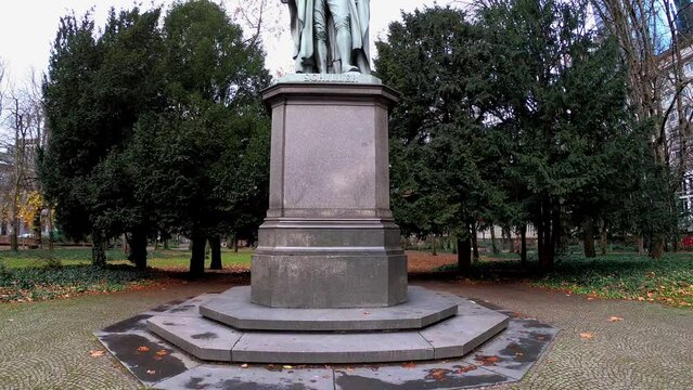 Frankfurt am Main, Germany, December 7, 2021: TILT SHOT SLOW MOTION - The Schiller Monument. Unveiled on 09th May 1864, the monument was moved to the Taunusanlage in May 1955.