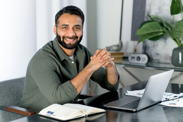 Portrait of a positive creative Indian or Arabian man wearing casual stylish clothes, company...