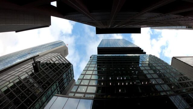 Frankfurt am Main, Germany, December 7, 2021: DOLLY - Skyscrapers and commercial buildings in the financial district of Frankfurt. Tall glass buildings. View of tall modern buildings from the ground.