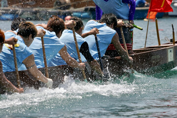 Fototapeta people racing a dragon boat obraz
