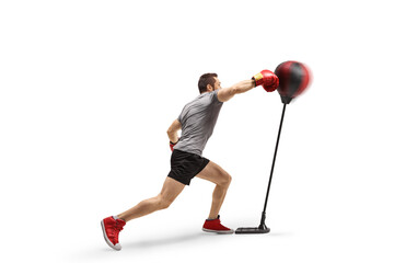 Athlete punching a free standing boxing bag