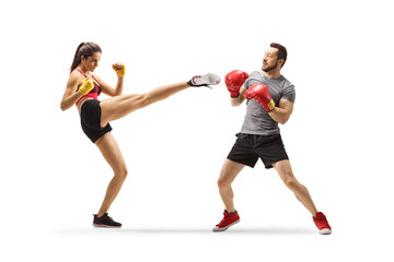 Young man and woman exercising kick box
