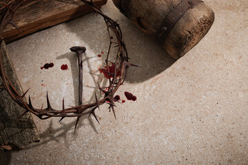 Fototapeta na wymiar Crucifixion Of Jesus Christ. Wooden Cross With Nails And Crown Of Thorns on stone background