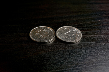 Coin of two rubles on a black table