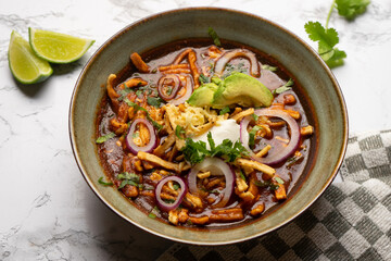 Tortilla soup with avocado and cheese. Mexican food