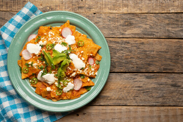 Red chilaquiles with cheese and avocado. Mexican food