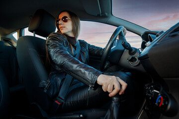 Fototapeta na wymiar Young woman switching rear gear driving a car