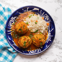 Meatballs with chipotle red sauce and rice. Mexican food