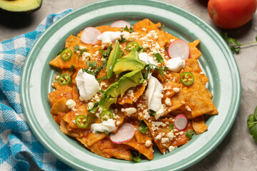 Red chilaquiles with cheese and avocado. Mexican food