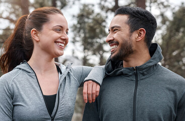 Exercising outdoors makes it feel like youre on a mini adventure. Shot of a sporty young man and woman exercising outdoors.