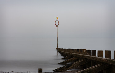 Long Exposure of a groyne and marker in the Firth of Forth on a misty day