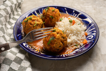 Meatballs with chipotle red sauce and rice. Mexican food