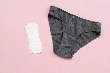 Top view white sanitary napkin and underpants isolated on pink background. Woman hygiene, Concept of critical days, menstruation,health care