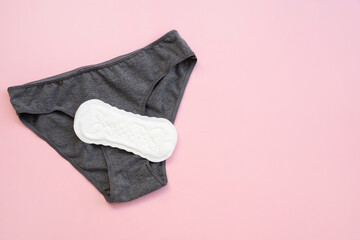 Top view white sanitary napkin and underpants isolated on pink background. Woman hygiene, Concept of critical days, menstruation,health care