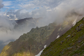 mountain ridge in dense mist and clouds, mountain travel background