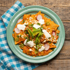 Red chilaquiles with cheese and avocado. Mexican food