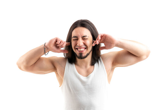 Picture of handsome guy with beard plugging his ears with fingers, isolated over white background. High quality photo
