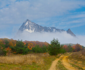 snowbound mountain ridge in mist and dense clouds
