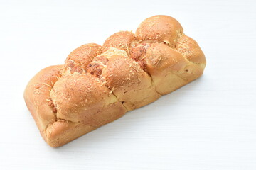 Big bread with cheese, grated parmesa cheese on white wooden background