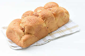 Big bread with cheese, grated parmesa cheese on white wooden background