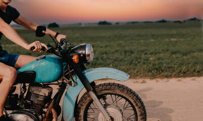 retro vintage motorcycle custom cafe racer rides on a country road.