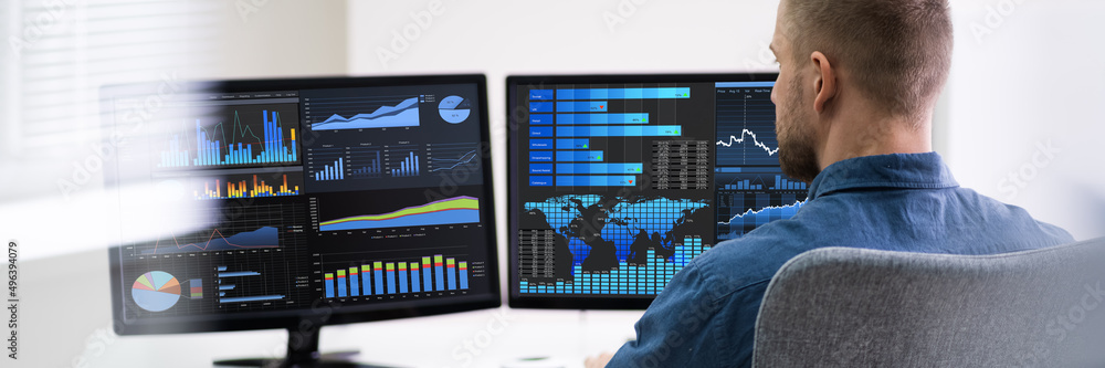 Poster businessman analyzing graphs on computer