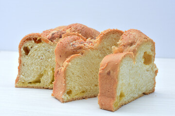 Big bread with cheese, grated parmesa cheese on white wooden background