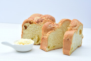 Big bread with cheese, grated parmesa cheese on white wooden background